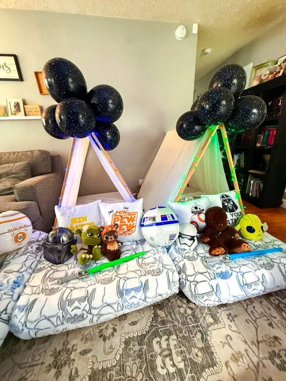 Camp Far, Far Away sleepover setup: Yoda, an Ewok, Chewie and the droids tucked in and waiting.