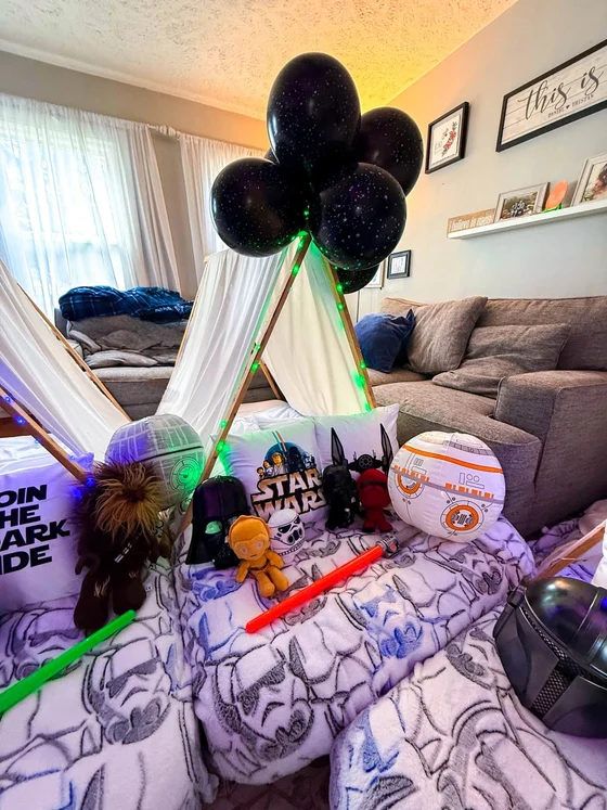 Camp Far, Far Away sleepover setup: Death Star and BB-8 lanterns, lightsabers and creatures from across the galaxy.