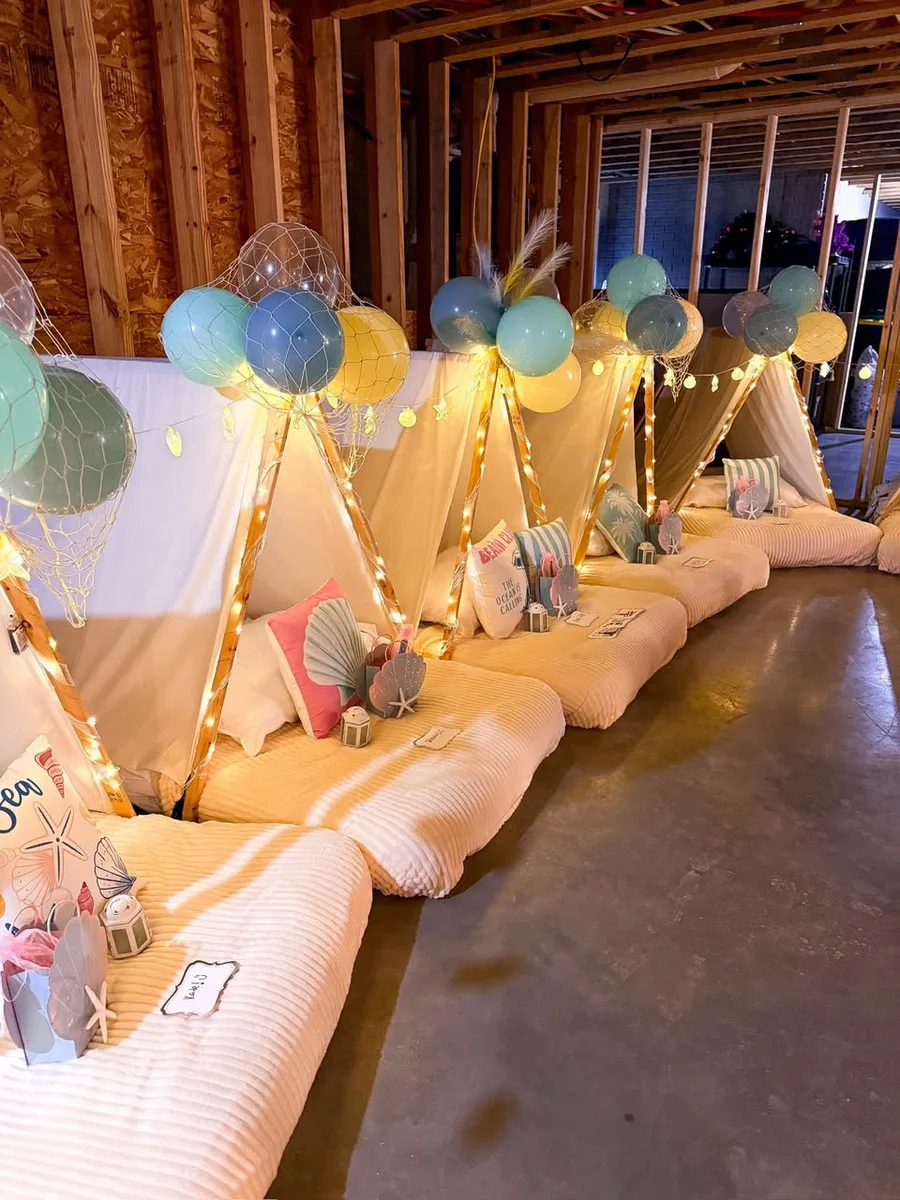A row of styled teepee tents set up and waiting before guests arrive