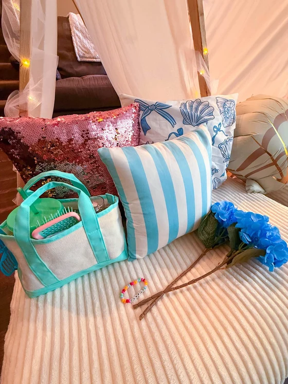 The Summer I Turned Pretty sleepover setup: A tote packed for the night, stripes and blue hydrangeas.
