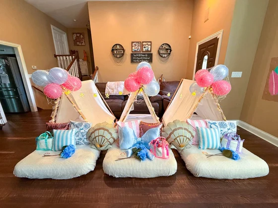 The Summer I Turned Pretty sleepover setup: Three tents across the room with the balloons up.