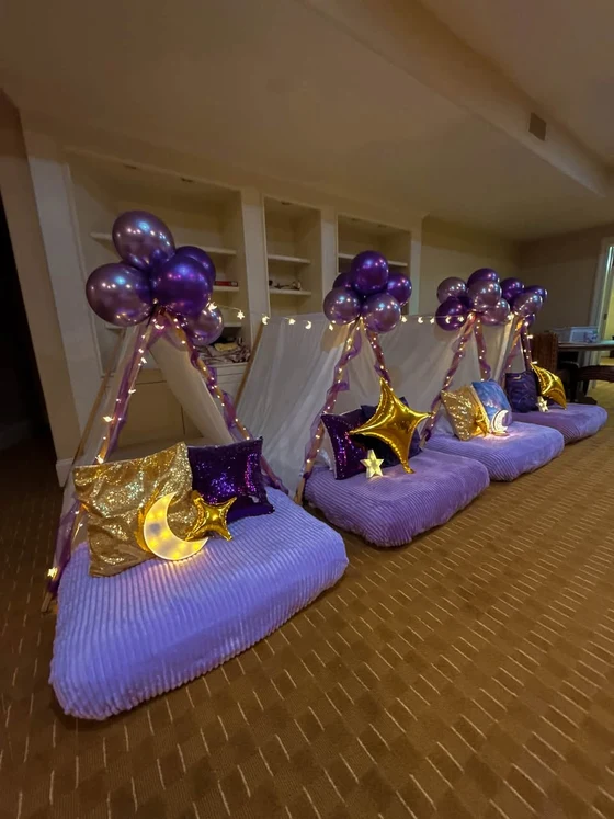 Violet Skies sleepover setup: Twinkling lights, moons and stars down the whole row.